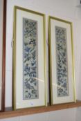A pair of 20th Century Chinese needlework panels decorated with birds and flowers, framed and