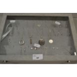 Display case containing various silver and white metal necklaces, earrings etc