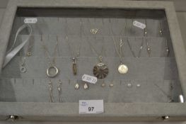 Display case containing various silver and white metal necklaces, earrings etc