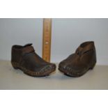 Pair of child's antique leather shoes with iron mounted soles