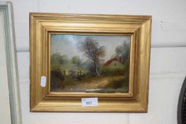 Small oil of a cottage on a lane in gilt frame