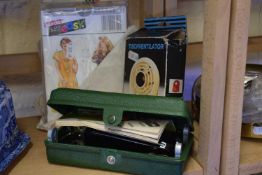 A quantity of vintage sewing patterns and an Singer button holer