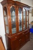 A reproduction break front glazed bookcase with mirror back
