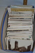 A shoe box of assorted postcards