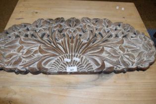 Carved hardwood panel with pierced floral design. 77cm wide