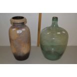 Glass carboy together with a West German pottery vase