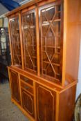 Reproduction yew wood bookcase cabinet with glazed top section and drawer and cupboard base, 145cm