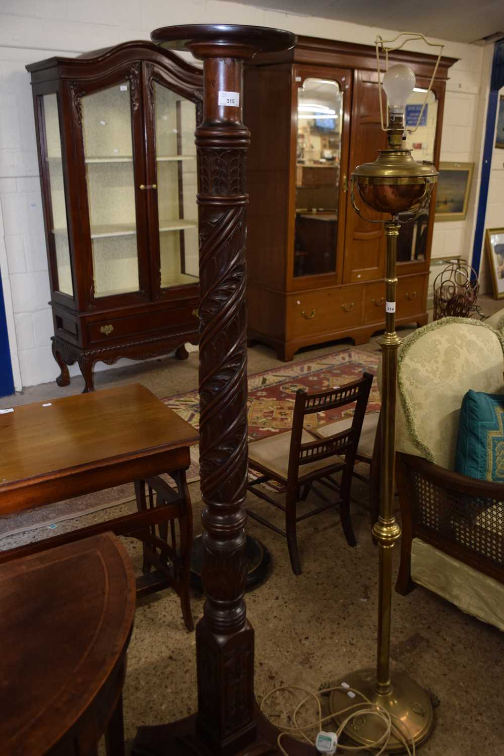 A hardwood torchere plant stand with card decoration, 161cm wide