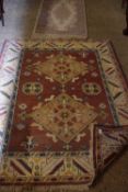 Modern Indian wool floor rug decorated with a large central red panel, 180cm long