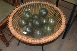 Mid Century woven circular glass top coffee table, the centre filled with glass witches type balls