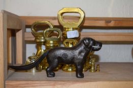 A set of brass weights together with a nut cracker formed as a dog