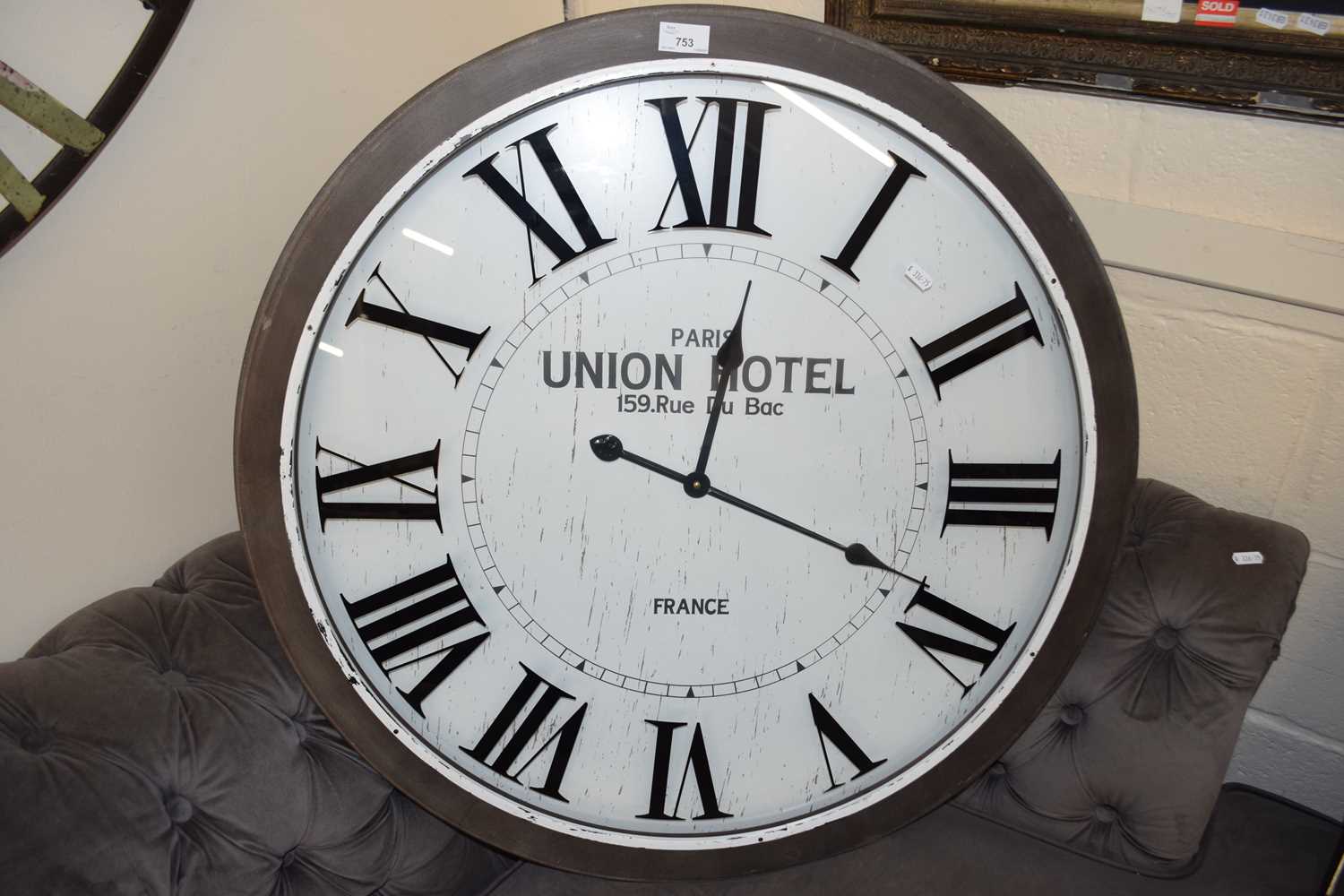 Large modern wall clock marked Paris Union Hotel, 77cm diameter