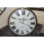 Large modern wall clock marked Paris Union Hotel, 77cm diameter