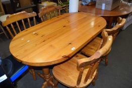 Varnished pine kitchen table and four matching chairs