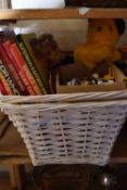 Basket containing various toys including die cast vehicles, TV interest annual books etc