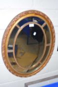 20th Century oval wall mirror in gilt finish frame