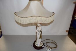 A continental porcelain lamp with a Capodimonte figure, impressed signature for B Merlin, the figure
