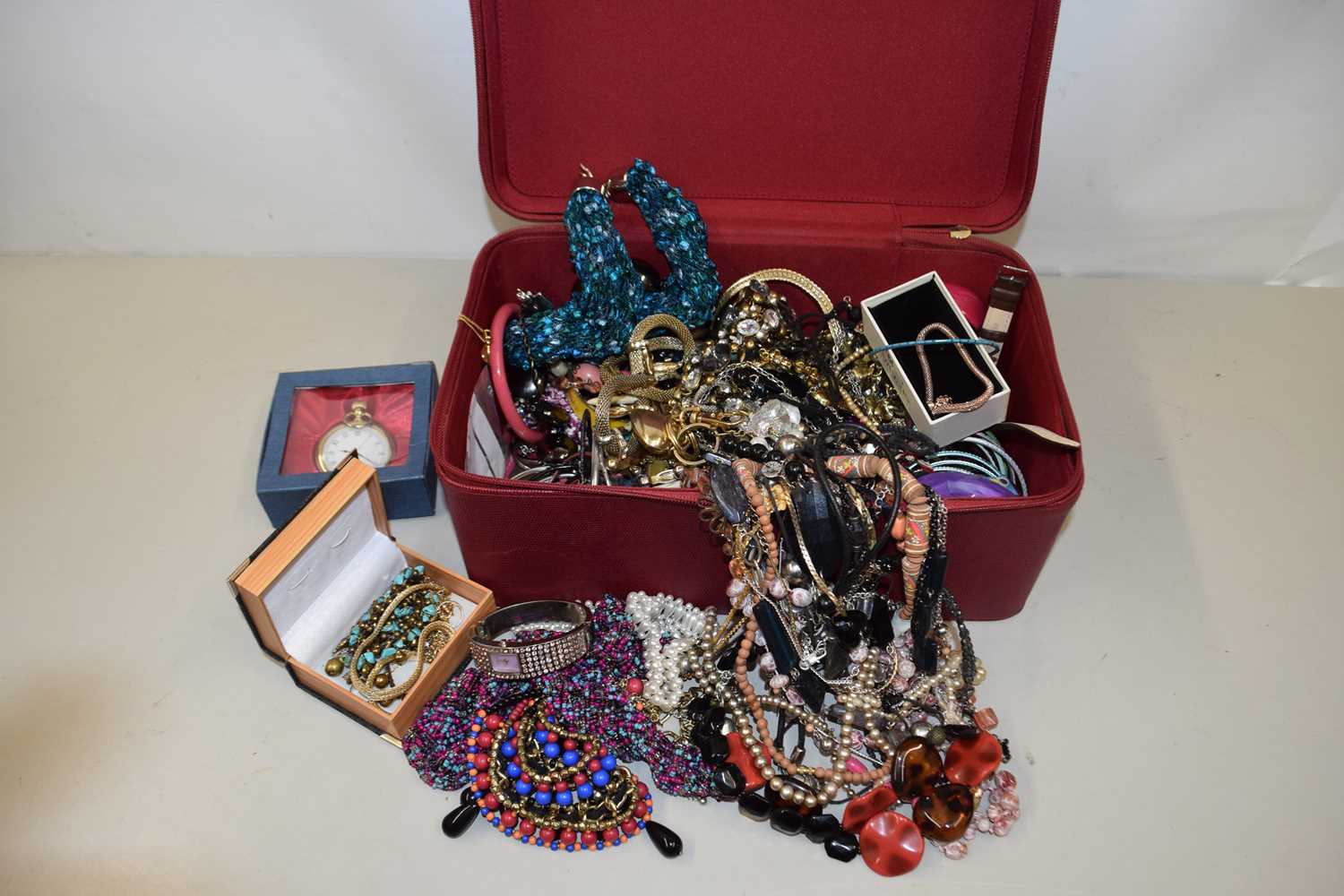 Red case containing various assorted costume jewellery