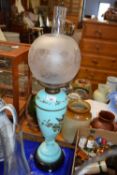 Victorian oil lamp with frosted glass shade and with an eggshell blue glass font decorated with