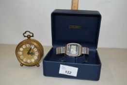 Vintage Seiko digital watch and a small brass cased bedside clock