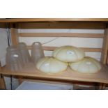 Three milk glass ceiling shades together with three frosted glass lampshades