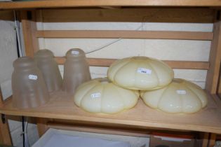 Three milk glass ceiling shades together with three frosted glass lampshades