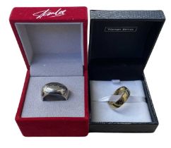 A pair of boxed replica plated rings, to include: - Stan Lee: Excelsior (Size S-T) - Lord of the