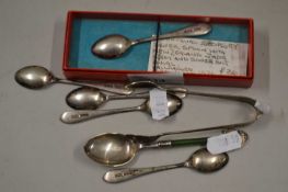 A small quantity of silver teaspoons to include one with a jadeite handle and a pair of sugar tongs