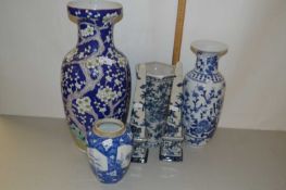 Chinese porcelain vase with prunus decoration on a blue ground together with other Chinese vases and