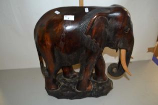 Large wooden carved elephant on rectangular base