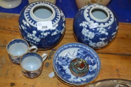Pair of Chinese porcelain ginger jars, the blue ground with prunus decoration (one a/f) together