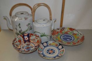 Two Japanese porcelain kettles with wicker handles