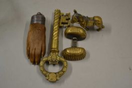 A large brass key together with a miniature donkey, a silver mounted paw etc
