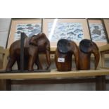 Wooden elephant book end and a pair of carved wooden elephants