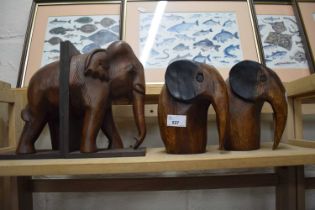 Wooden elephant book end and a pair of carved wooden elephants