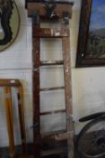 A folding wooden step ladder