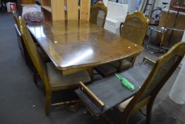 A twin pedestal extending dining table with two extra leaves and five matching chairs