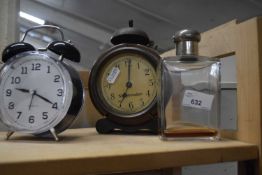 Two alarm clocks and a vintage scent bottle