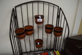 An metal plant stand and pots
