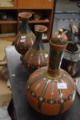 Three terracotta and polychrome glazed vases