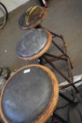 A pair of vintage bar stools and another similar
