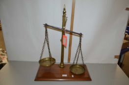 Pair of brass beam scales with mahogany plinth base