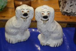 Pair of Staffordshire model spaniels with gilt highlights