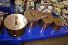 Graduated set of four copper saucepans