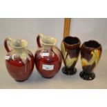 Pair of small German red glazed jugs together with a further pair of German vases (4)