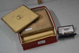 Box containing a set of place mats, tie clips etc