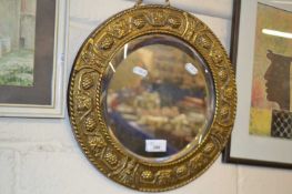 20th century circular bevelled wall mirror in a pressed brass frame