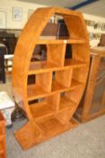 Art Deco style walnut veneered shelf unit of oval form, 161cm high