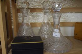 Three decanters and an Arthur Price pair of dwarf candlesticks, cased