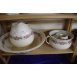 Washbowl and jug set decorated with pink flowers and ribbons